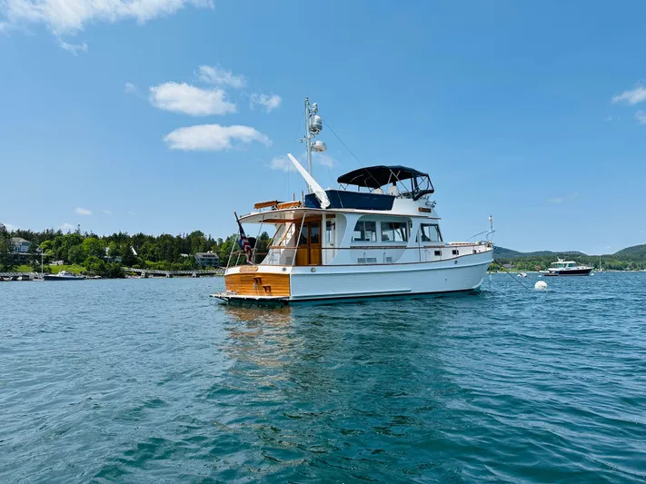 Liberty Yacht Photos Pics 2003 Grand Banks 46 Europa yacht on calm water under clear blue sky.