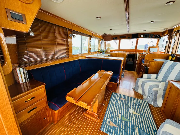 Liberty Yacht Photos Pics Luxurious interior of 2003 Grand Banks 46 Europa yacht with wooden furnishings and blue seating.