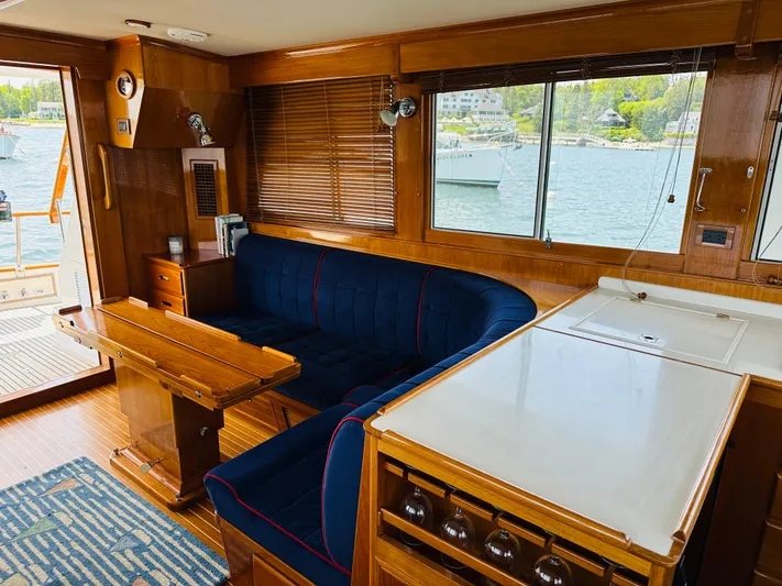 Liberty Yacht Photos Pics Interior of 2003 Grand Banks 46 Europa yacht with wooden furnishings and blue seating.