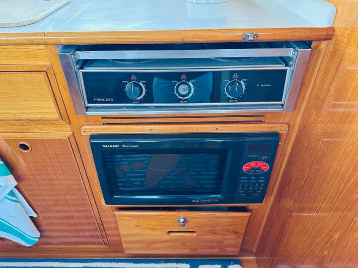 Liberty Yacht Photos Pics Galley appliances on 2003 Grand Banks 46 Europa yacht, featuring stove and microwave.