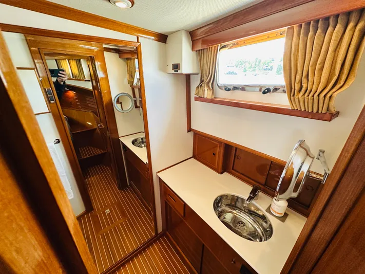 Liberty Yacht Photos Pics Luxurious 2003 Grand Banks 46 Europa yacht interior with wood finish and modern amenities.