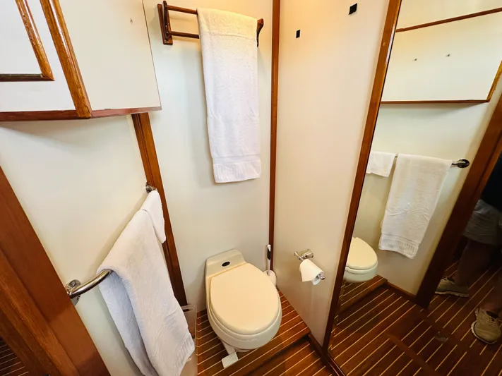 Liberty Yacht Photos Pics Bathroom interior of 2003 Grand Banks 46 Europa yacht with wooden accents and white towels.