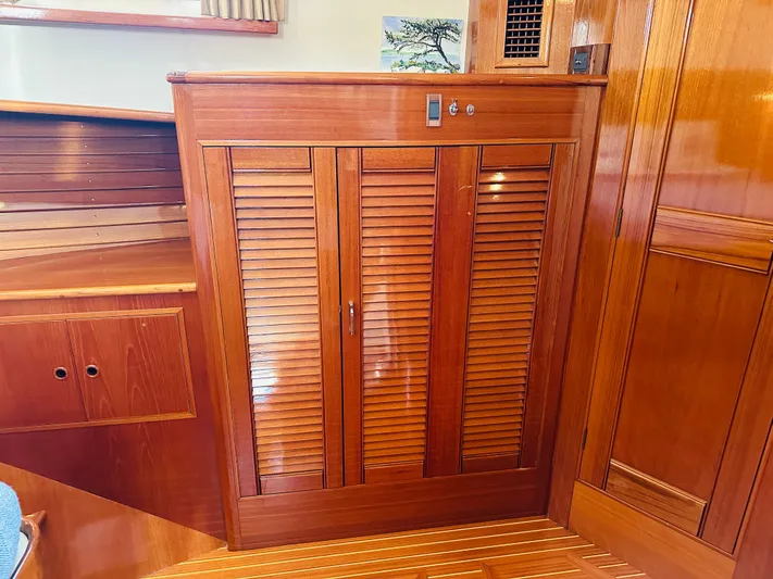 Liberty Yacht Photos Pics Wooden interior of 2003 Grand Banks 46 Europa yacht, featuring louvered cabinet doors.