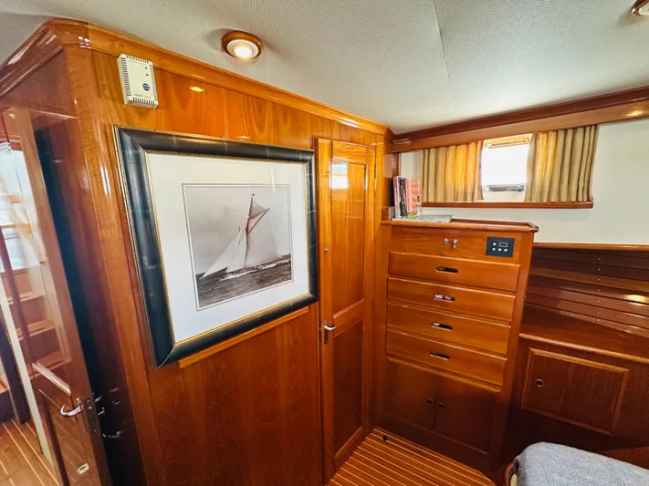 Liberty Yacht Photos Pics Interior of 2003 Grand Banks 46 Europa yacht with wooden cabinetry and framed sailboat artwork.