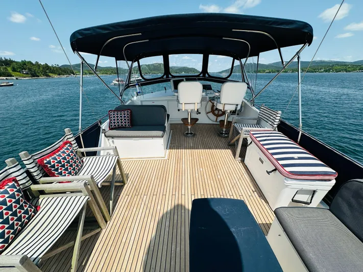 Liberty Yacht Photos Pics 2003 Grand Banks 46 Europa yacht deck with seating, canopy, and scenic water view.