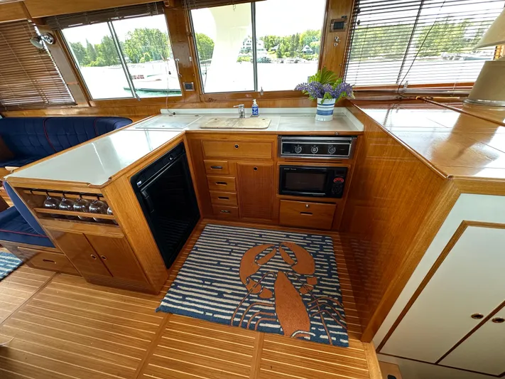 Liberty Yacht Photos Pics Luxurious 2003 Grand Banks 46 Europa yacht kitchen with wood cabinetry and nautical decor.
