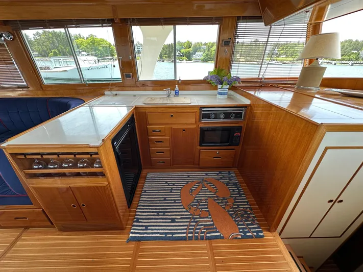 Liberty Yacht Photos Pics Interior of 2003 Grand Banks 46 Europa yacht with wooden cabinetry and nautical-themed decor.