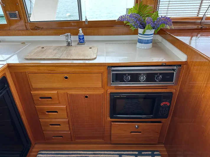 Liberty Yacht Photos Pics Galley of 2003 Grand Banks 46 Europa with wooden cabinetry and modern appliances.