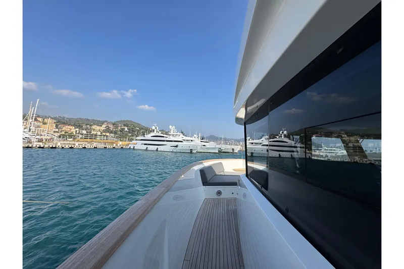 Maoria Yacht Photos Pics 2021 Numarine 26XP yacht docked in scenic marina with clear blue skies.