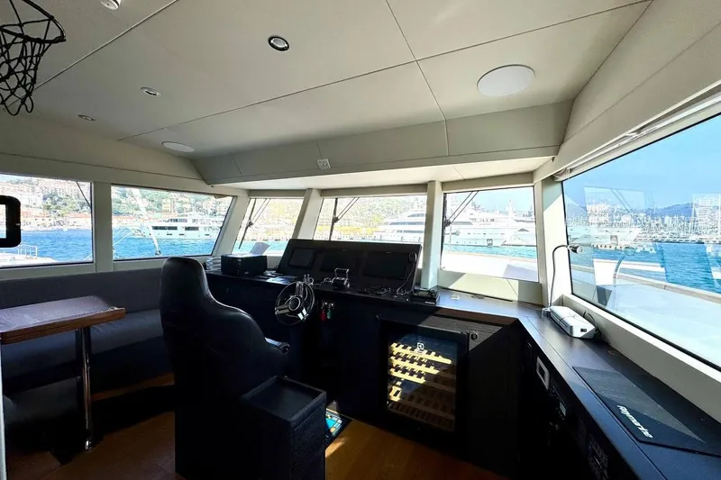 Maoria Yacht Photos Pics Interior view of 2021 Numarine 26XP yacht helm with panoramic windows and modern controls.