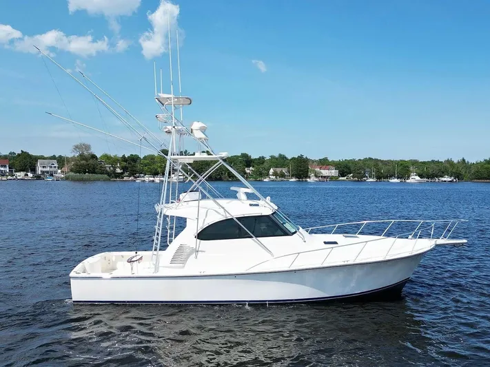  Yacht Photos Pics 2022 Henriques 42 Express Hardtop boat on calm water under clear blue sky.