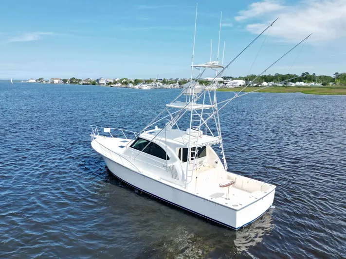  Yacht Photos Pics 2022 Henriques 42 Express Hardtop boat on calm water under clear blue sky.