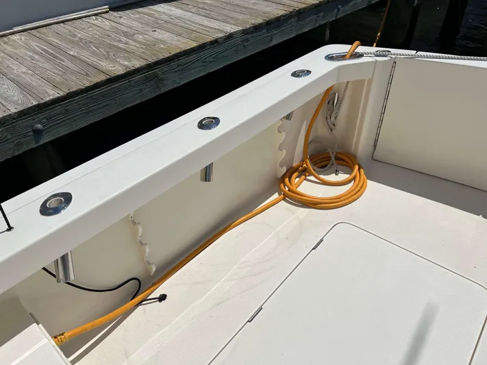  Yacht Photos Pics 2022 Henriques 42 Express Hardtop boat deck with coiled orange cable and dock view.