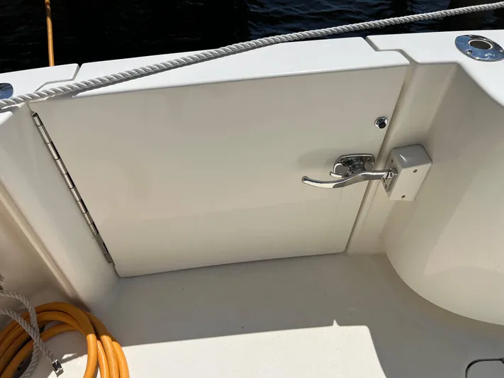  Yacht Photos Pics 2022 Henriques 42 Express Hardtop boat deck with latch and coiled rope.