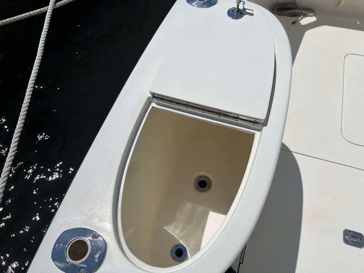  Yacht Photos Pics Open storage compartment on 2022 Henriques 42 Express Hardtop boat deck.