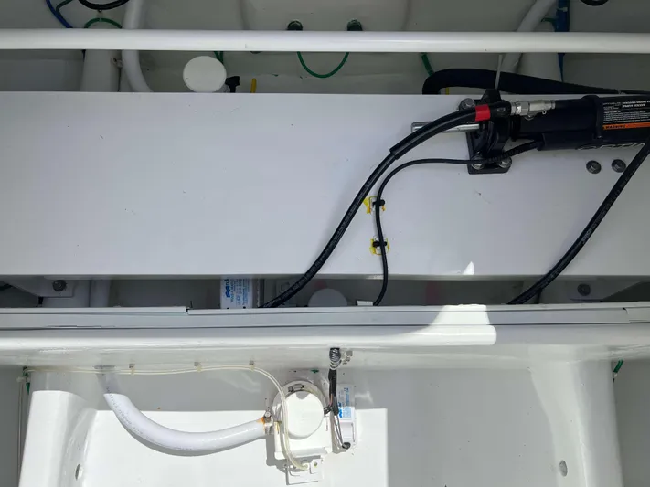  Yacht Photos Pics Engine compartment of a 2022 Henriques 42 Express Hardtop boat, showing hydraulic and electrical components.