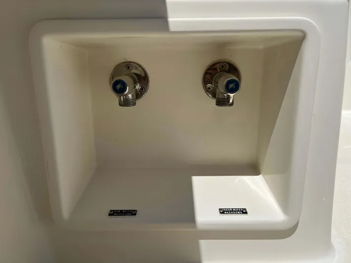  Yacht Photos Pics Water connections on a 2022 Henriques 42 Express Hardtop boat, labeled for raw and fresh water.