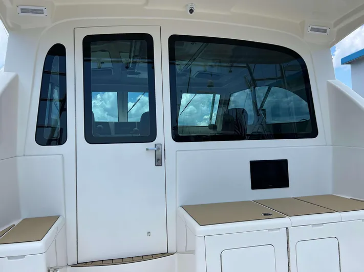  Yacht Photos Pics 2022 Henriques 42 Express Hardtop boat interior with seating and glass door.