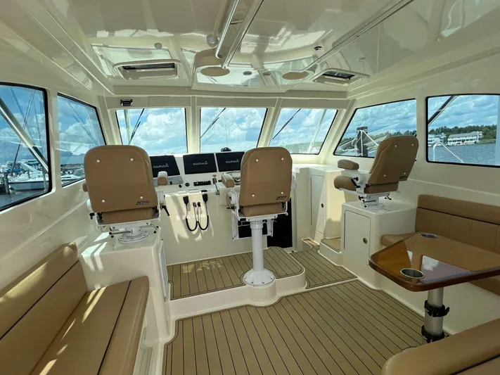  Yacht Photos Pics Interior of 2022 Henriques 42 Express Hardtop boat with seating and navigation equipment.