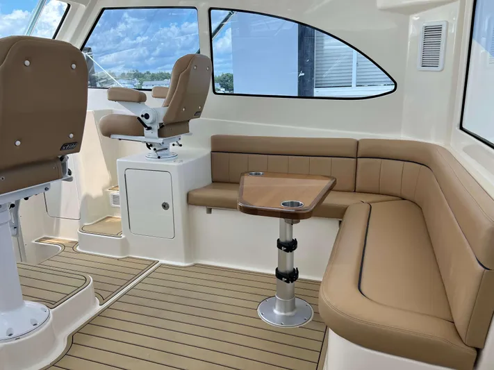  Yacht Photos Pics Interior of 2022 Henriques 42 Express Hardtop with tan seating and wooden table.