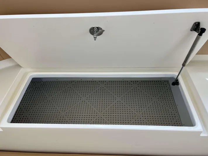  Yacht Photos Pics Open storage compartment on 2022 Henriques 42 Express Hardtop boat, featuring a secure latch and hydraulic support.