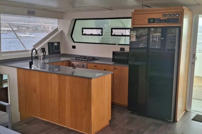  Yacht Photos Pics Modern kitchen interior on 2024 Leeuwin 55 yacht with sleek design and appliances.