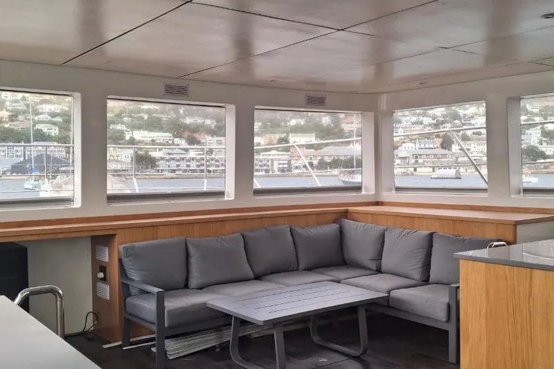  Yacht Photos Pics Luxurious interior of 2024 Leeuwin 55 yacht with panoramic windows and comfortable seating.