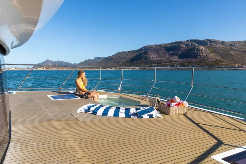  Yacht Photos Pics Luxury yacht deck with jacuzzi, woman relaxing, ocean view, Leeuwin 55, 2024 model.