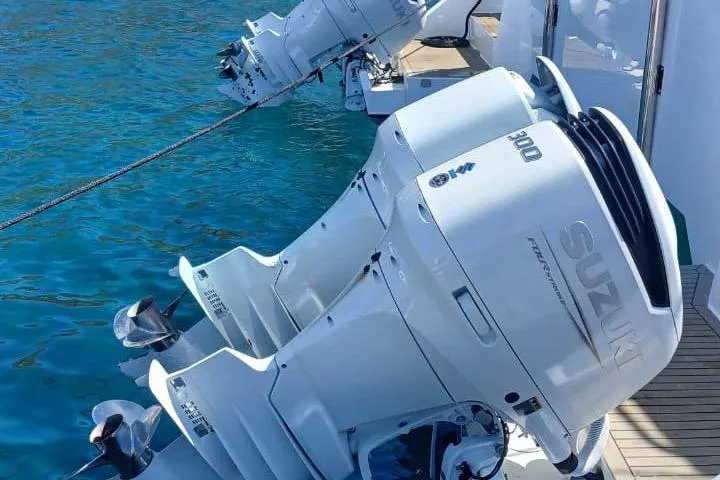  Yacht Photos Pics Outboard motors on a 2024 Leeuwin 55 boat, docked in clear blue water.
