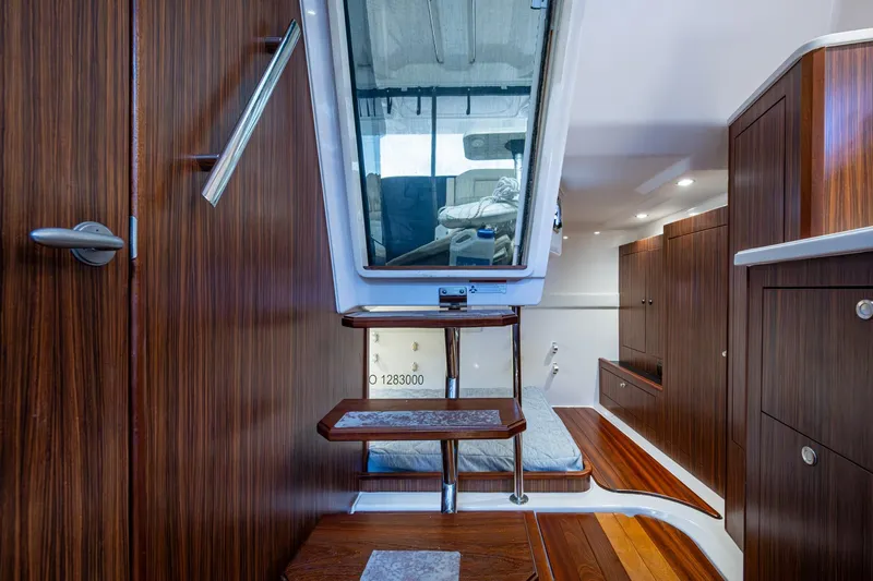  Yacht Photos Pics Luxurious Pursuit boat interior with wooden cabinetry and modern design.
