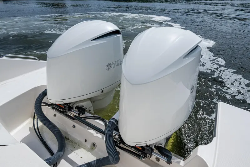  Yacht Photos Pics Twin Yamaha outboard motors on a Pursuit boat, cruising on water.