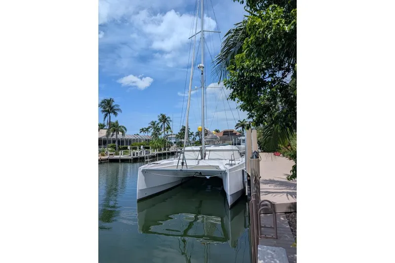 Sea Hugger Yacht Photos Pics 2016 Nautitech 40 Open catamaran docked by palm trees under blue sky.