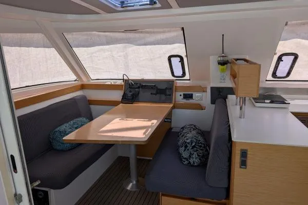 Sea Hugger Yacht Photos Pics Interior of 2016 Nautitech 40 Open catamaran with dining area and navigation equipment.
