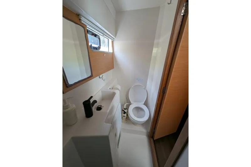 Sea Hugger Yacht Photos Pics Compact bathroom in 2016 Nautitech 40 Open catamaran, featuring toilet and sink.