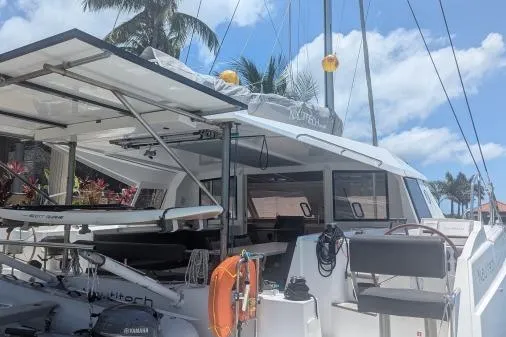 Sea Hugger Yacht Photos Pics 2016 Nautitech 40 Open catamaran docked under palm trees with clear blue sky.