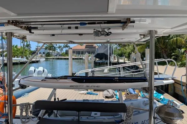 Sea Hugger Yacht Photos Pics Nautitech 40 Open catamaran docked, featuring paddleboard and scenic waterfront view.