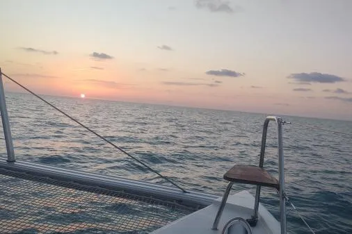 Sea Hugger Yacht Photos Pics Sunset view from 2016 Nautitech 40 Open catamaran on the ocean.