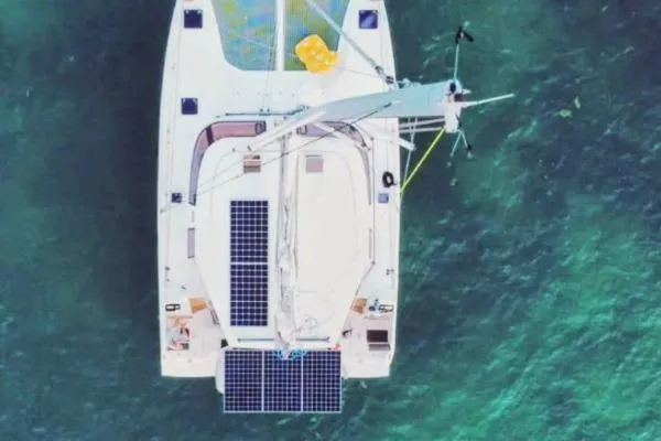 Sea Hugger Yacht Photos Pics Overhead view of 2016 Nautitech 40 Open catamaran with solar panels on turquoise water.