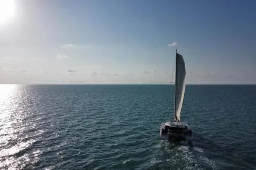 Sea Hugger Yacht Photos Pics Sailing catamaran Nautitech 40 Open 2016 on open sea under clear sky.