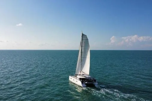 Sea Hugger Yacht Photos Pics Sailing catamaran Nautitech 40 Open 2016 on open sea under clear blue sky.