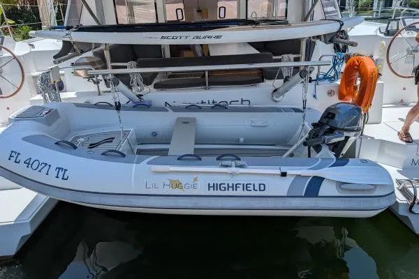 Sea Hugger Yacht Photos Pics Inflatable boat attached to a 2016 Nautitech 40 Open catamaran, docked with safety equipment.