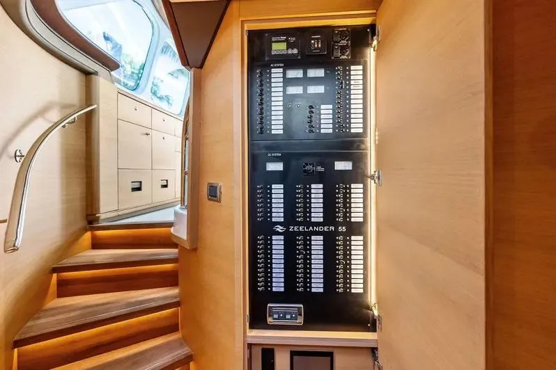 Dutch Yacht Photos Pics Electrical panel inside 2019 Zeelander Z55 yacht, featuring wooden interior and staircase.
