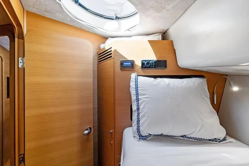 Dutch Yacht Photos Pics Luxurious cabin interior of 2019 Zeelander Z55 yacht with wooden finish and cozy bedding.