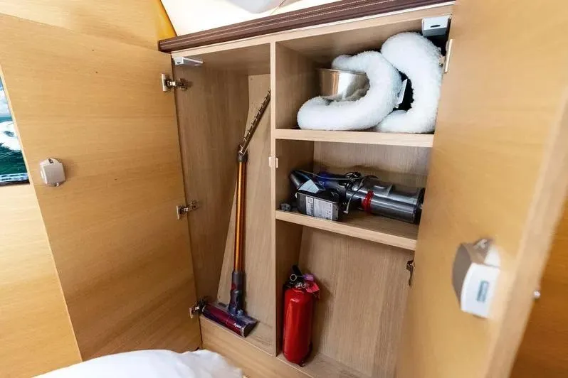 Dutch Yacht Photos Pics Storage cabinet on 2019 Zeelander Z55 yacht with cleaning tools and fire extinguisher.