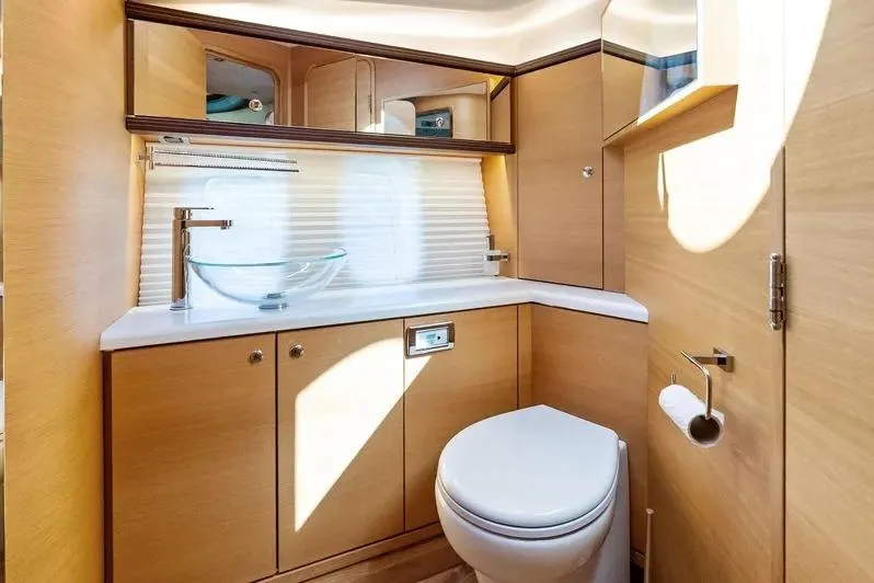 Dutch Yacht Photos Pics Luxurious 2019 Zeelander Z55 yacht bathroom with modern fixtures and wooden cabinetry.