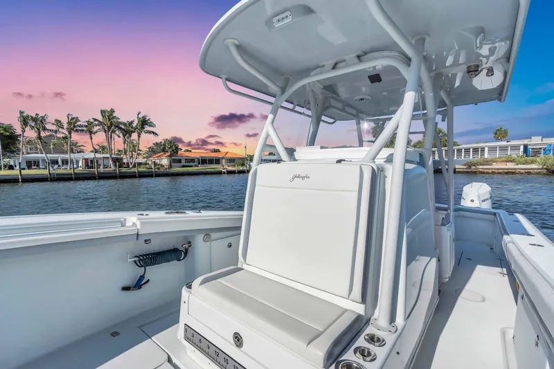  Yacht Photos Pics 2021 Yellowfin 36 Offshore boat on water at sunset, featuring sleek design and spacious deck.