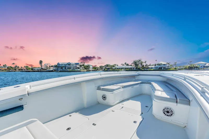 Yacht Photos Pics 2021 Yellowfin 36 Offshore boat at sunset, featuring spacious deck and waterfront view.
