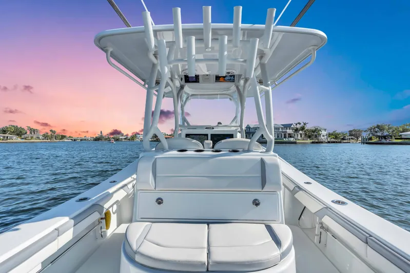  Yacht Photos Pics 2021 Yellowfin 36 Offshore boat on water at sunset, showcasing sleek design and spacious deck.