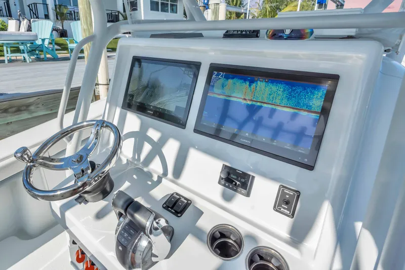  Yacht Photos Pics 2021 Yellowfin 36 Offshore boat dashboard with dual screens and steering wheel.