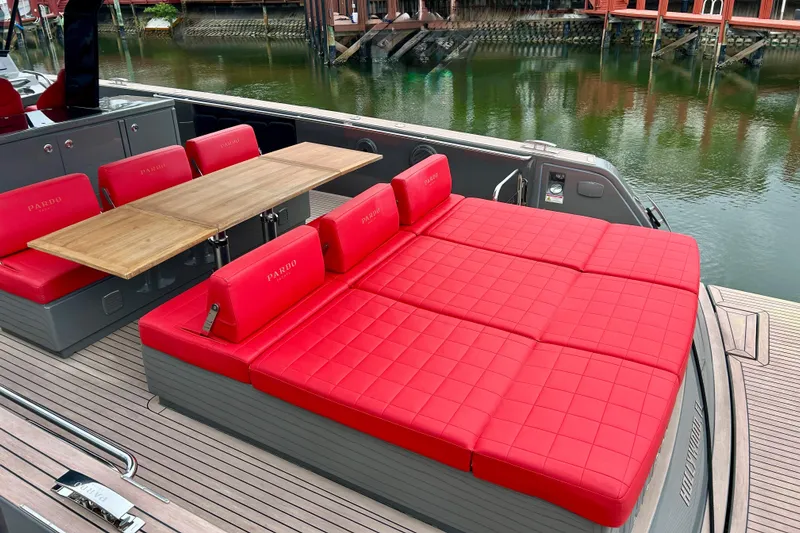Odessa Mama Yacht Photos Pics 2023 Pardo Yachts 43 with red seating and wooden table on deck.